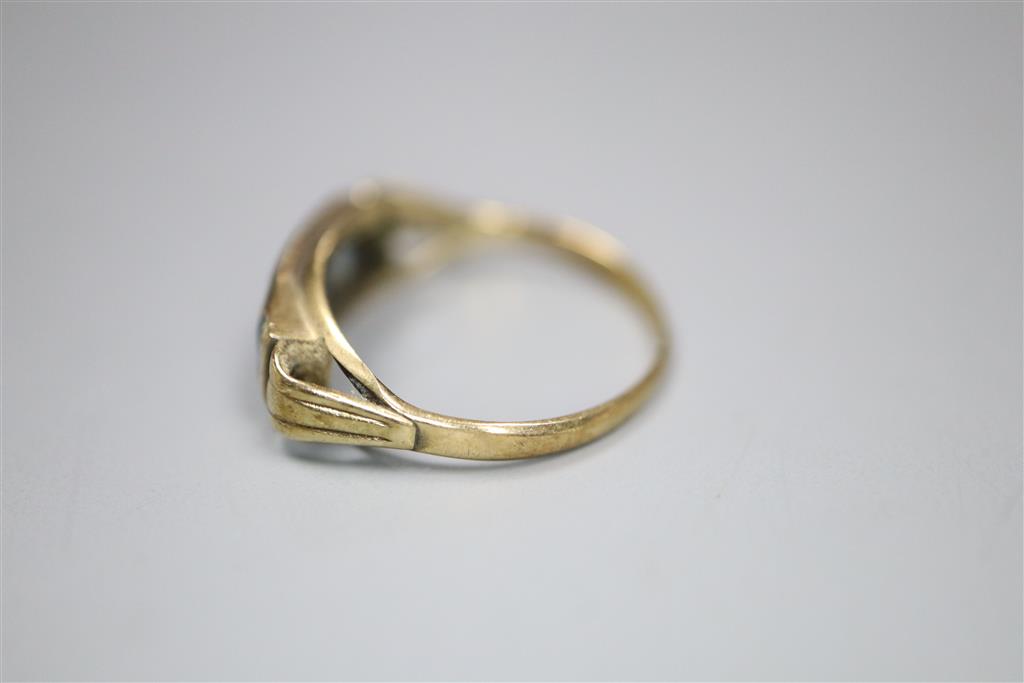 A 333 (8ct) yellow metal and channel set three stone blue topaz? ring, size J, gross 1.4 grams.